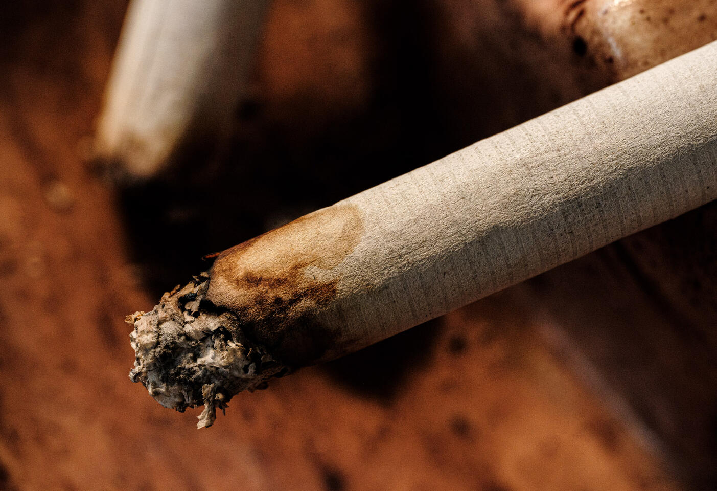 Burnt end of natural american spirit cigarette in ashtray.